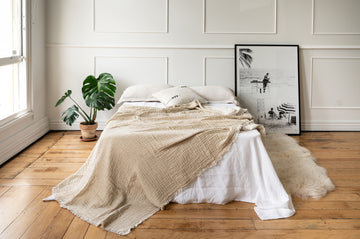 A chic apartment bedroom setting with Nomad Linen blanket 